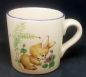 Preview: Keramik-Tasse  - Becher mit Wunschname – Motiv: 1 x Hase mit blauer Blume – Flower Bunny